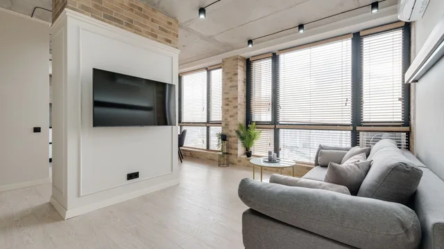 TV installerad på väggen i ett vardagsrum.